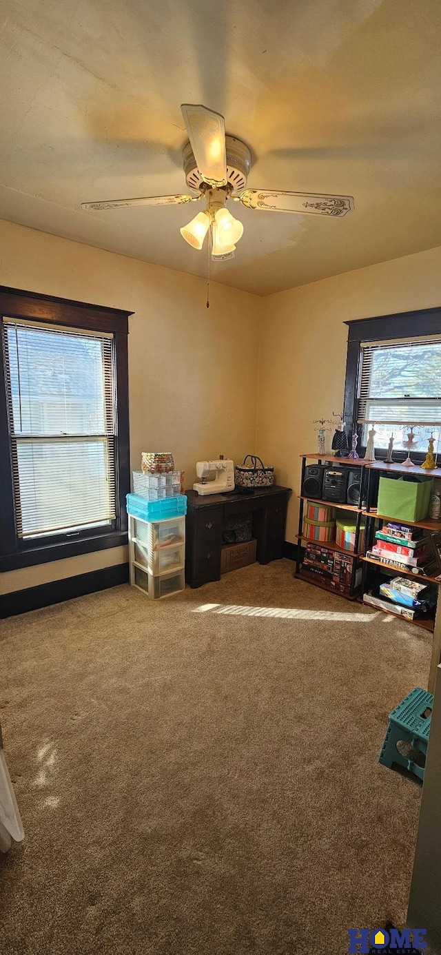 game room featuring a ceiling fan, carpet flooring, and a healthy amount of sunlight