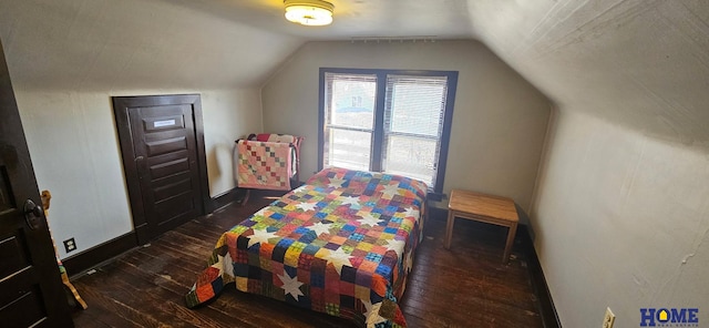 bedroom with dark wood finished floors, lofted ceiling, and baseboards