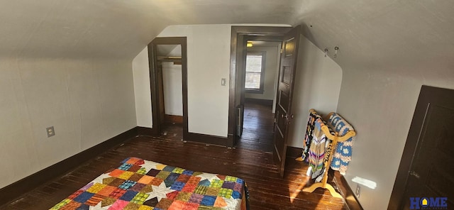 additional living space featuring baseboards, vaulted ceiling, and hardwood / wood-style flooring