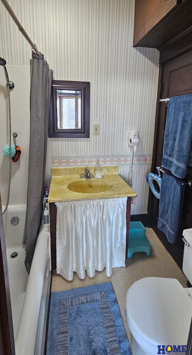 bathroom featuring wallpapered walls, toilet, and vanity