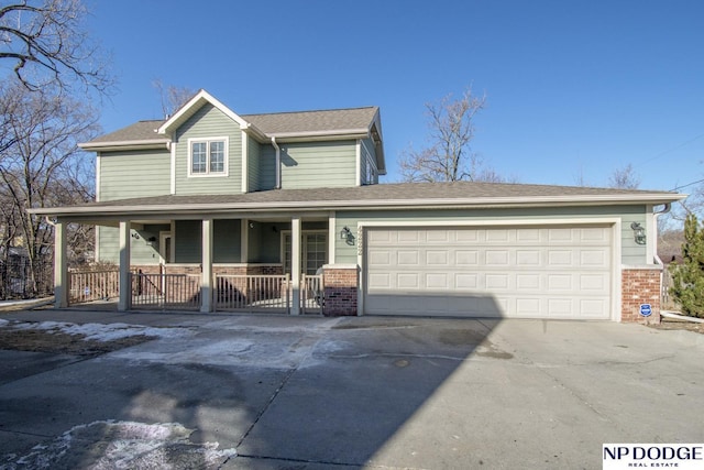 view of front of house featuring brick siding, driveway, a porch, and a garage