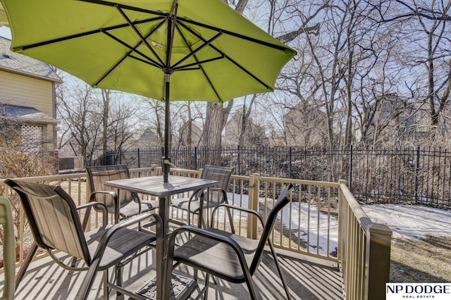 wooden deck with outdoor dining space and fence