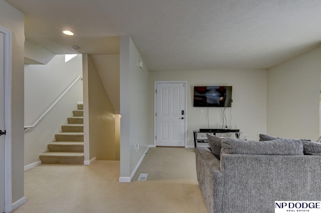 living area featuring recessed lighting, baseboards, carpet, and stairs