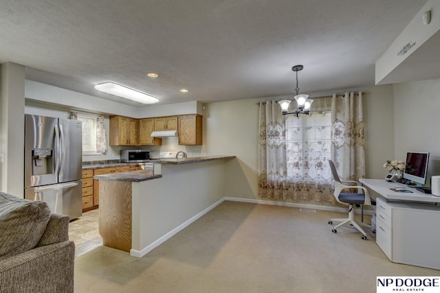 kitchen featuring baseboards, under cabinet range hood, a peninsula, an inviting chandelier, and stainless steel appliances