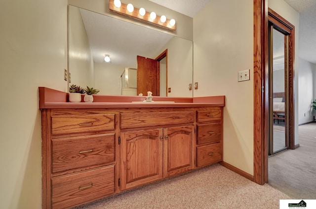 bathroom featuring visible vents, baseboards, carpet floors, and vanity