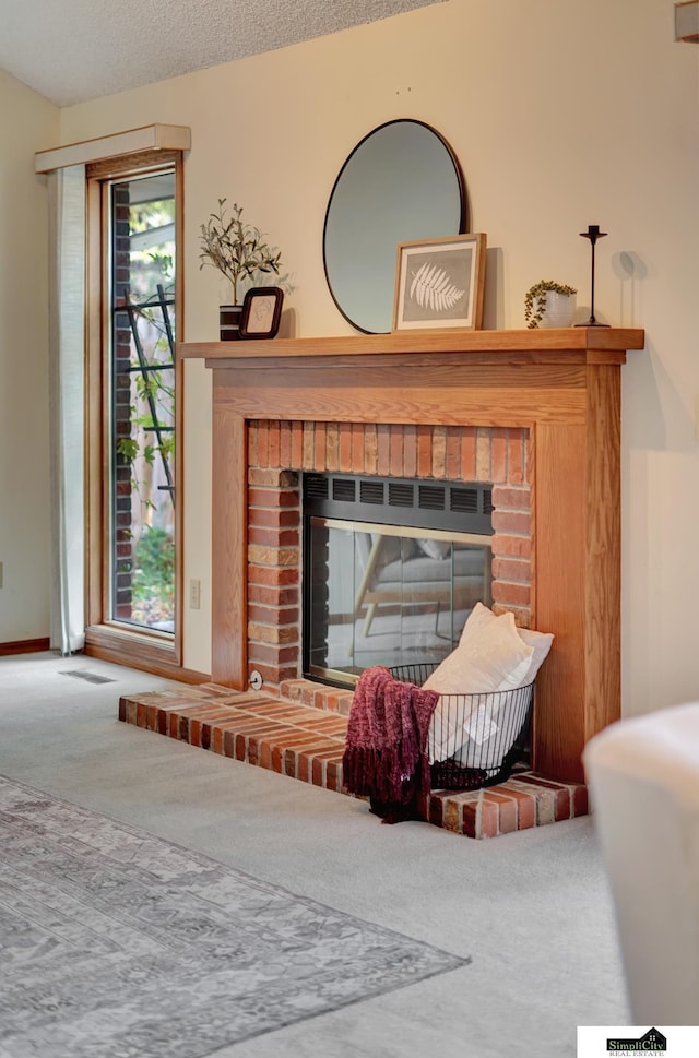 details with carpet, a brick fireplace, and a textured ceiling