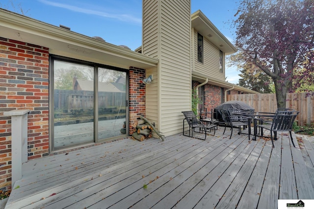 wooden terrace featuring fence