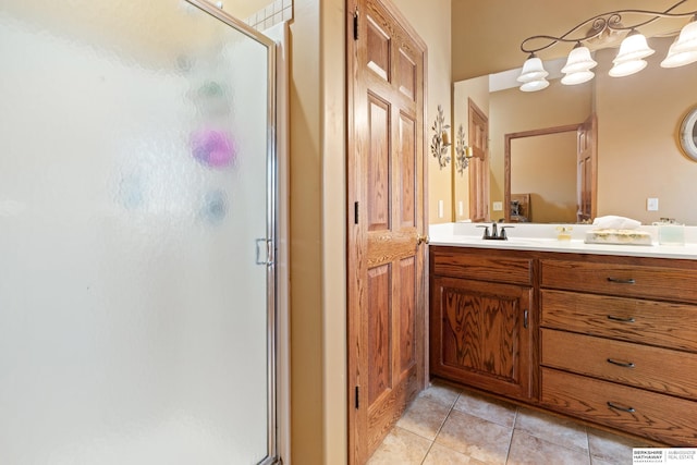 bathroom with a stall shower, vanity, and tile patterned flooring