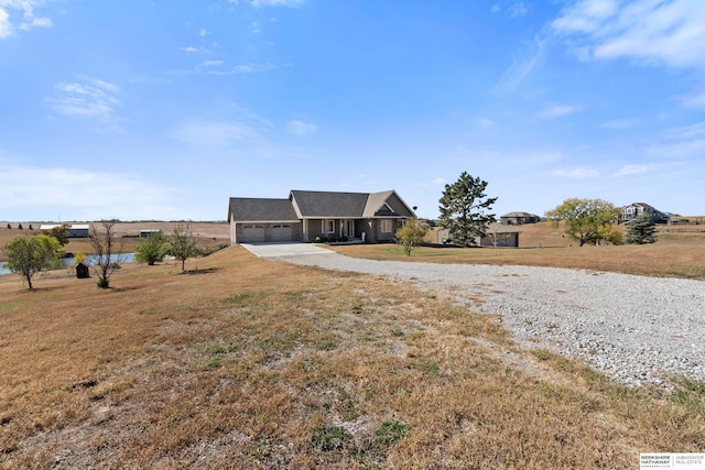 view of front of property with a garage, driveway, and a front lawn