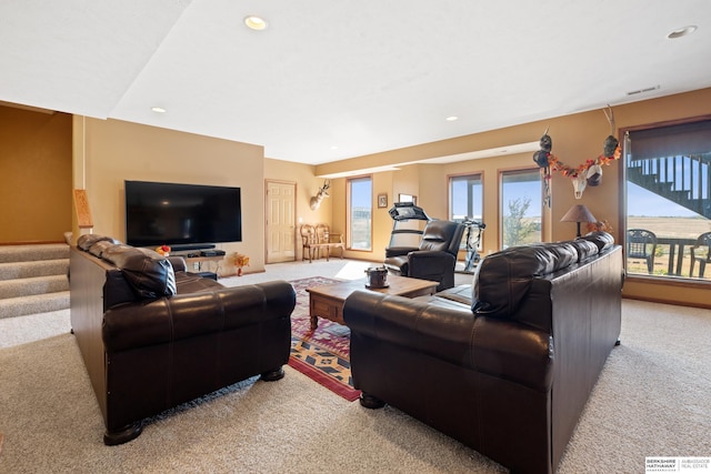 carpeted living room featuring recessed lighting, visible vents, and stairs