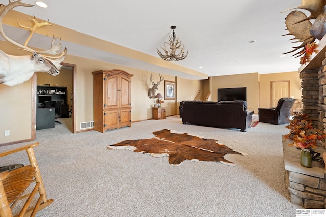 carpeted living room featuring visible vents and baseboards