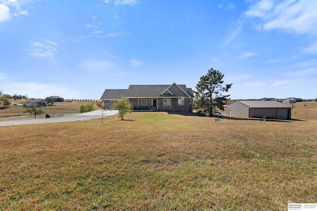 view of front of home featuring an outbuilding and a front yard