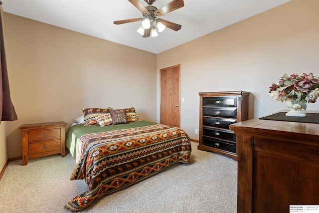 bedroom featuring baseboards, light carpet, and ceiling fan