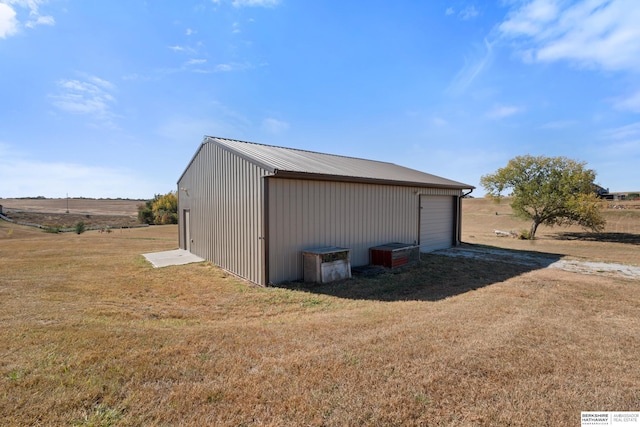 view of pole building featuring a lawn and driveway