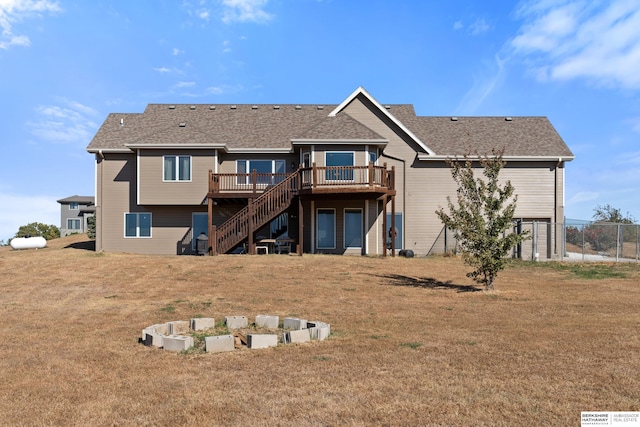 back of house with a lawn, a wooden deck, stairs, and fence