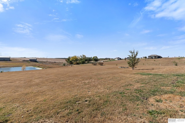 view of yard featuring a rural view and a water view