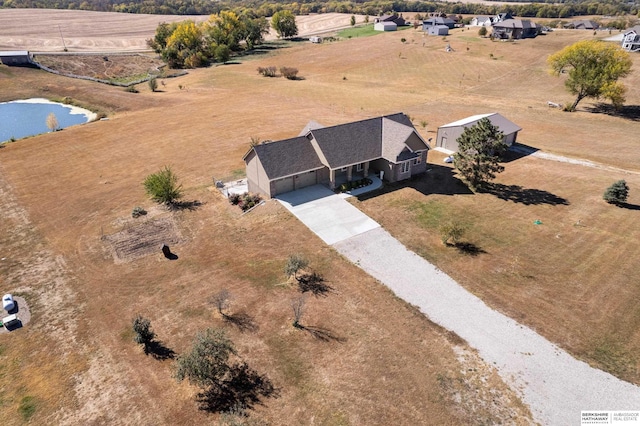 bird's eye view with a water view and a rural view