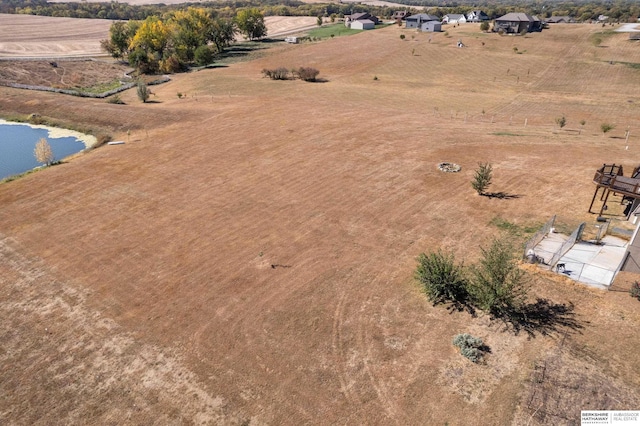 drone / aerial view with a water view and a rural view