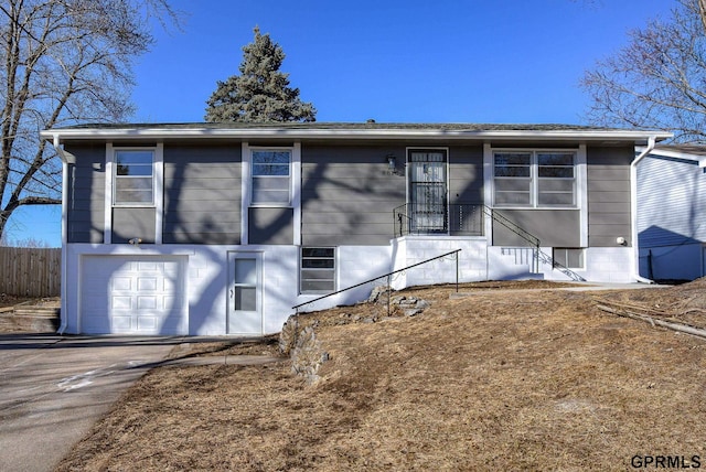 view of front of house featuring aphalt driveway and fence