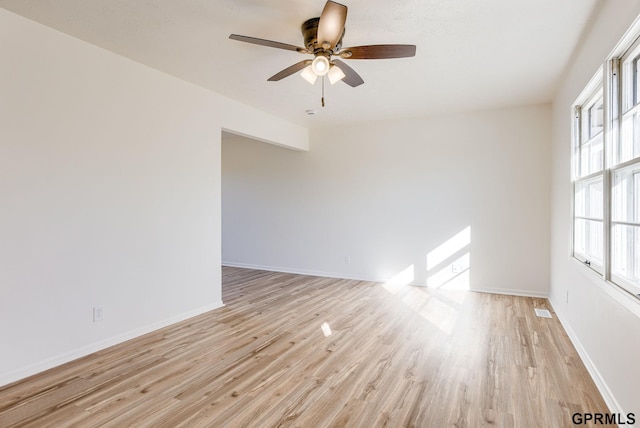 empty room with light wood-type flooring, baseboards, and a ceiling fan