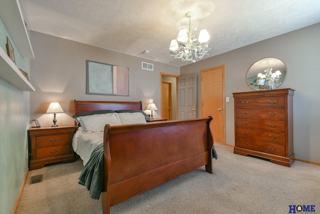 bedroom with visible vents, a notable chandelier, light colored carpet, and a textured ceiling