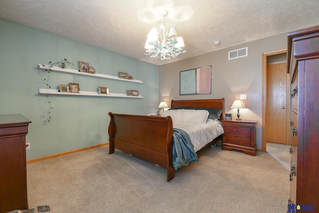 bedroom with visible vents, a textured ceiling, an inviting chandelier, and carpet floors