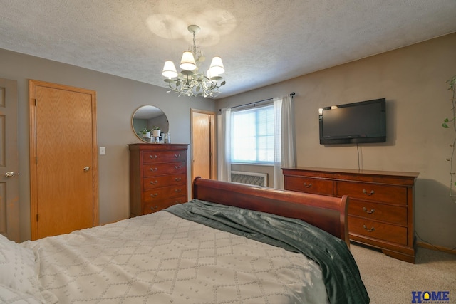 bedroom with light carpet, a notable chandelier, and a textured ceiling