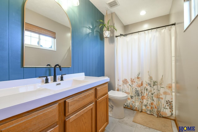 bathroom with visible vents, toilet, marble finish floor, curtained shower, and vanity