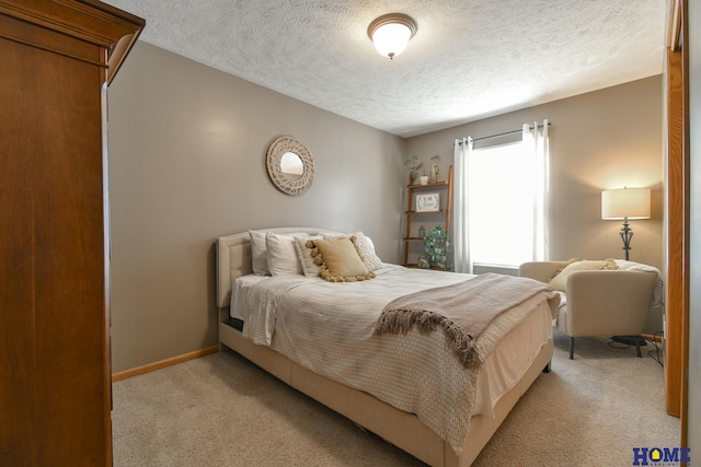 bedroom featuring a textured ceiling, baseboards, and light carpet