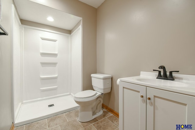 bathroom featuring baseboards, toilet, a shower stall, and vanity