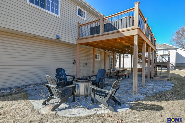 view of patio with a wooden deck, stairs, and an outdoor fire pit