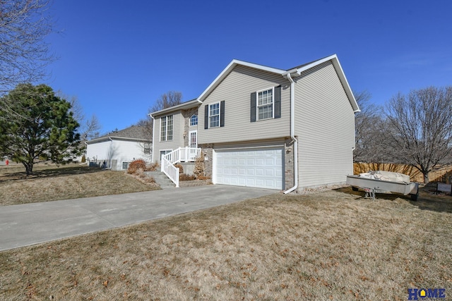 view of front of house featuring concrete driveway and an attached garage