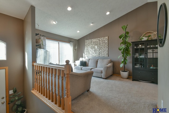 carpeted living area featuring recessed lighting and vaulted ceiling