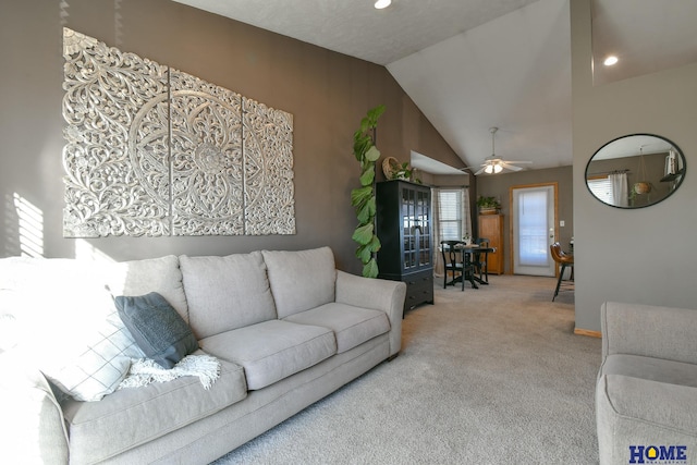 living room with light carpet, a ceiling fan, and vaulted ceiling