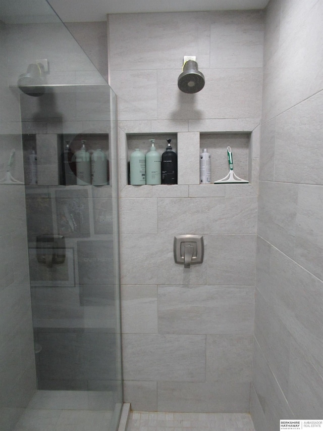 bathroom with a tile shower