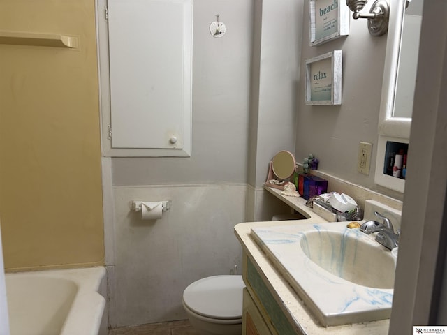 bathroom with vanity, toilet, and a bathing tub