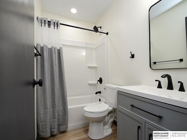 bathroom featuring shower / bath combo with shower curtain, toilet, wood finished floors, recessed lighting, and vanity