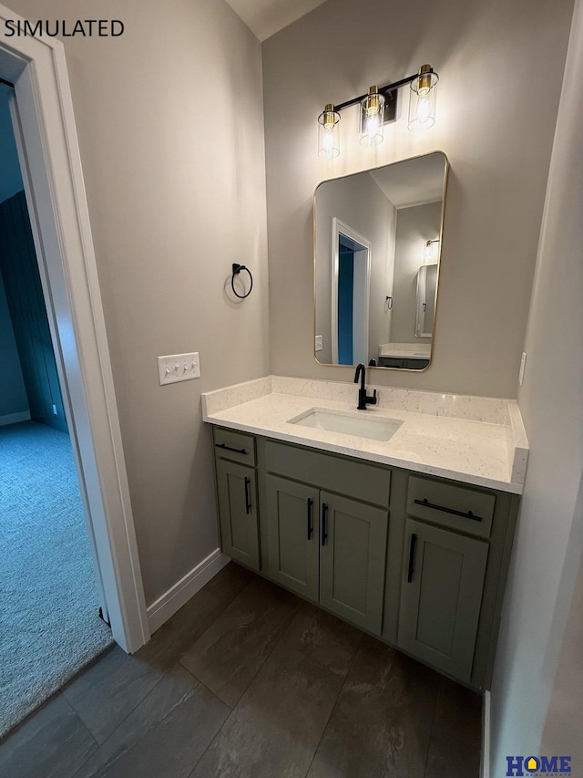 bathroom with vanity and baseboards