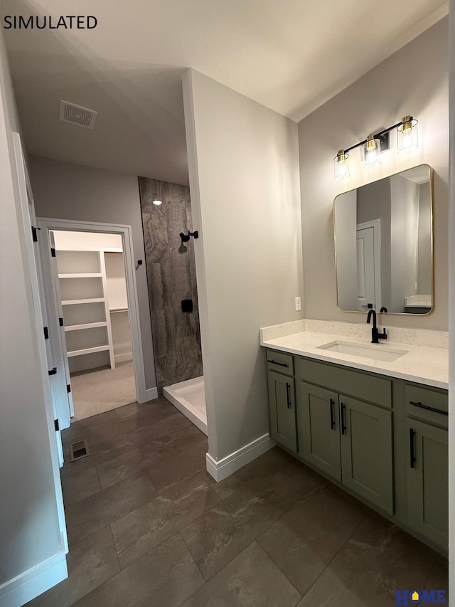 bathroom featuring vanity, visible vents, baseboards, and a stall shower