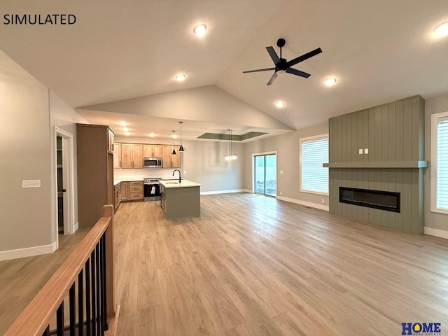 unfurnished living room featuring light wood-style flooring, baseboards, vaulted ceiling, and a ceiling fan