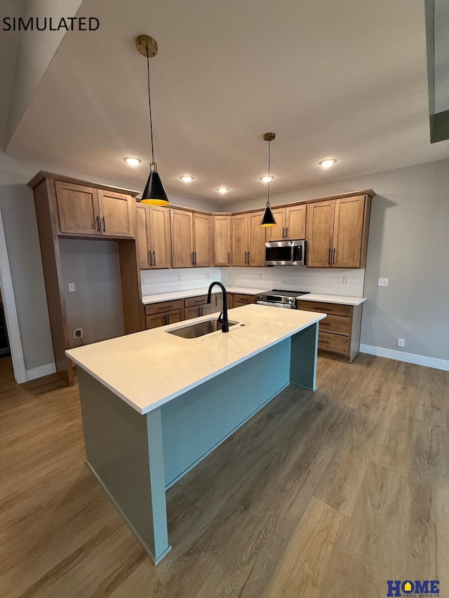 kitchen with baseboards, recessed lighting, decorative light fixtures, stainless steel appliances, and a sink