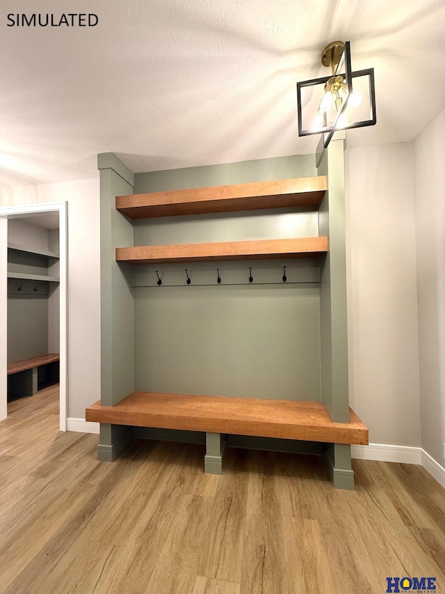 mudroom with light wood-style flooring and baseboards