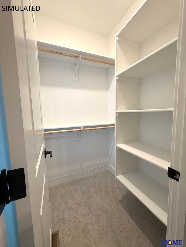 walk in closet featuring carpet flooring and visible vents