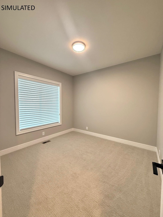 empty room with baseboards, carpet, and visible vents