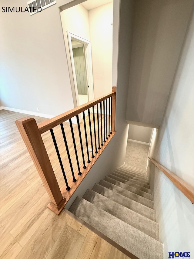 stairs with baseboards and wood finished floors