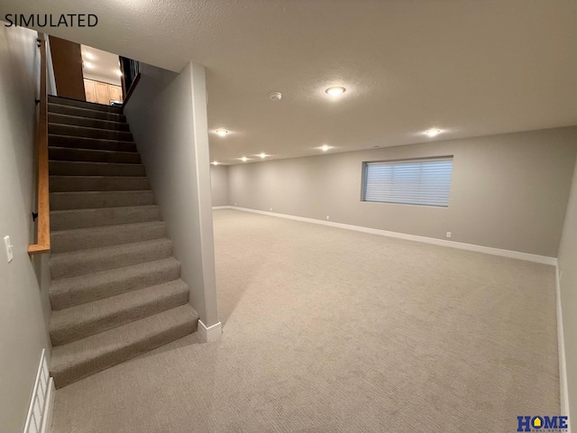 basement featuring carpet flooring, baseboards, recessed lighting, and stairway