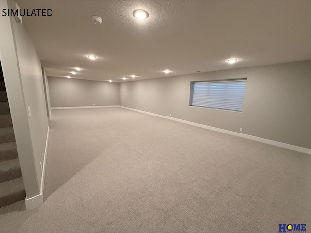 finished below grade area with baseboards, recessed lighting, and carpet