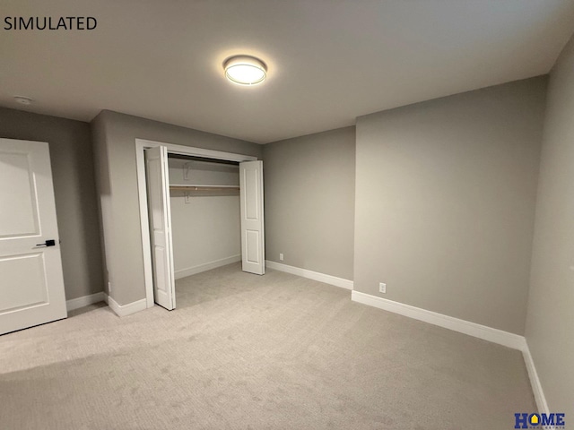 unfurnished bedroom featuring a closet, light colored carpet, and baseboards