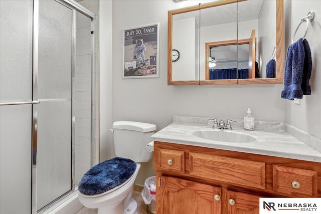 bathroom with vanity, toilet, and a stall shower