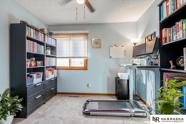 workout room with baseboards, carpet floors, a textured ceiling, and ceiling fan